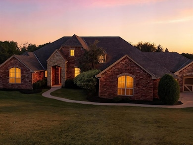 French country style house with a yard and stone siding