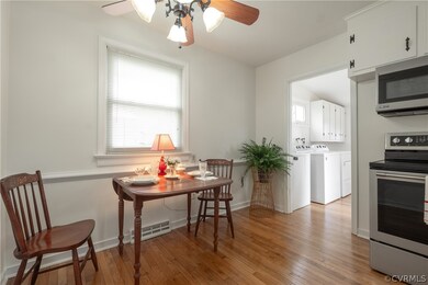 Dining space featuring washing machine and clothes