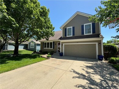View of front facade with a garage and a front lawn