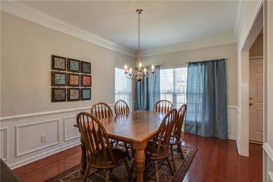 Upon entering into the foyer area, you will see the formal dining room on your right and powder room on your left.  Notice the large windows; plenty of natural light fills this spacious formal dining room! 