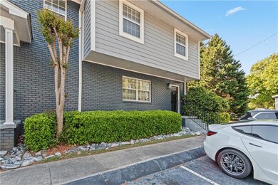 View of side of home with uncovered parking and br