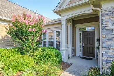 Beautiful landscaping and columns surround the fro