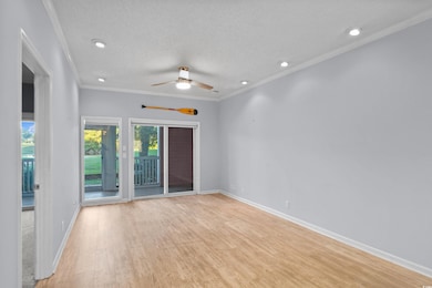Spare room featuring crown molding, a textured ceiling, recessed lighting, light wood-type flooring, and ceiling fan