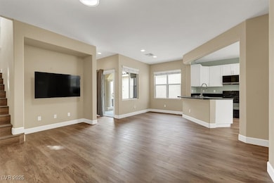 Unfurnished living room with baseboards, stairway,