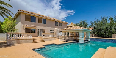 Rear view of house featuring a gazebo, an outdoor pool, a patio area, stucco siding, and a tiled roof