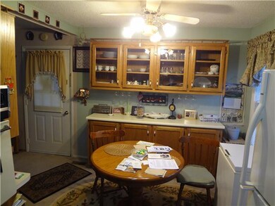 Other end of kitchen showing dining area and built in wall and base cabinets.