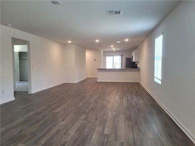 Unfurnished living room featuring dark wood-style