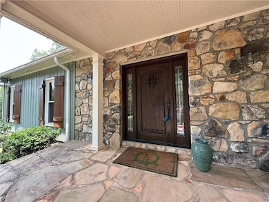 Doorway to property with stone siding