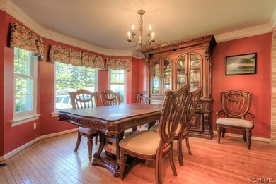 Dining Room featuring hardwood floors and crown mo