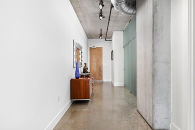 Hallway featuring concrete floors and baseboards