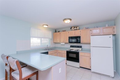Open kitchen with tile floors, breakfast bar and p