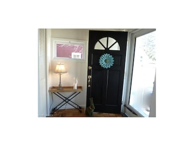 Foyer with Parquet Floors and Guest Closet