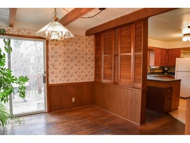 The dining room has hardwood flooring and a slider