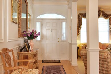 Foyer with wood floors and custom moldin