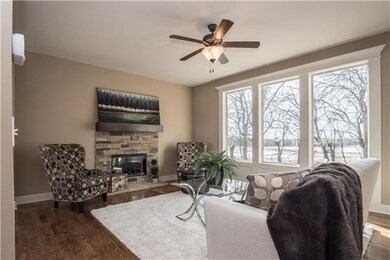 Open concept Hearth Room offers Stone Fireplace an