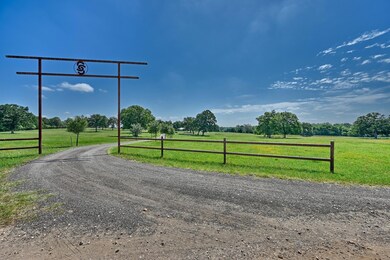 View of dirt / gravel road with a rural view