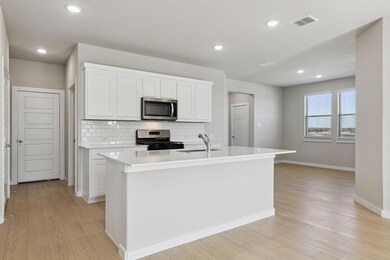 Kitchen with stainless steel appliances, a sink, 