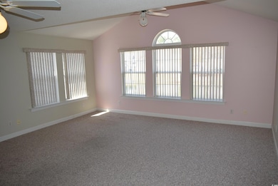 Carpeted spare room featuring baseboards, lofted c