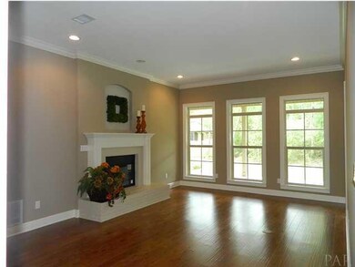 The great room offers large windows, crown molding, recessed lighting, and brick face fire place.