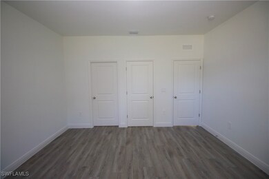 Master Bedroom with dark hardwood / vinyl-style fl