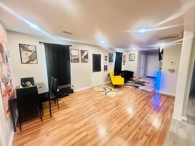 Living area with light hardwood / wood-style floor
