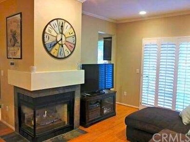 Living room has a gas-burning fireplace and slider