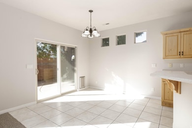 Unfurnished dining area with light tile patterned flooring and a chandelier