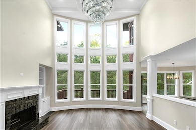 Unfurnished living room with a stone fireplace, a 