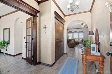 Entry hall features tile flooring & extensive crow