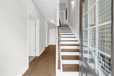 Stairway featuring wood finished floors and baseboards