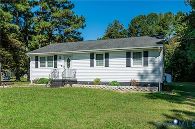 View of front of property featuring a front lawn and roof with shingles