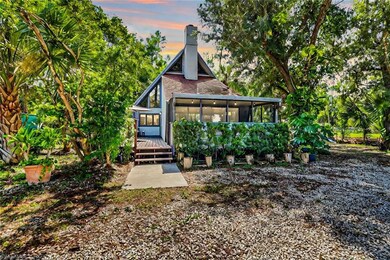 Back house at dusk featuring a sunroom and a deck