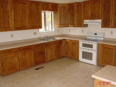 Large kitchen with lots of cabinets and counter sp