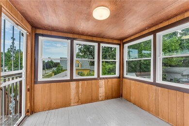 Unfurnished sunroom with wood ceiling