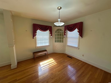 Unfurnished dining area featuring plenty of natural light and wood finished floors