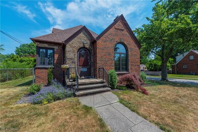 Front of brick bungalow with landscaping.