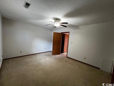 Carpeted spare room featuring a textured ceiling a