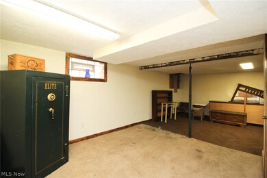 Basement with a textured ceiling and carpet flooring
