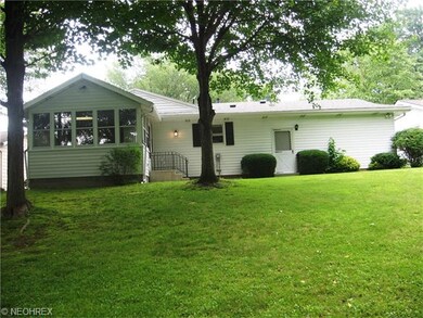 Back of house with sun room and patio and pedestri