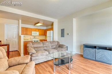 Living area featuring electric panel and light wood-type flooring