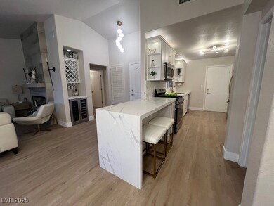 Kitchen featuring light stone countertops, light w