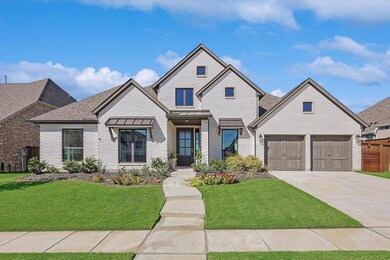 View of front of home with a garage and a front la