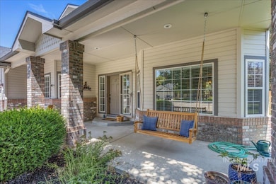 Doorway to property with a porch and brick siding