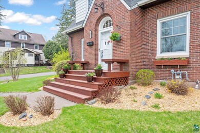 Property entrance with brick siding and a lawn