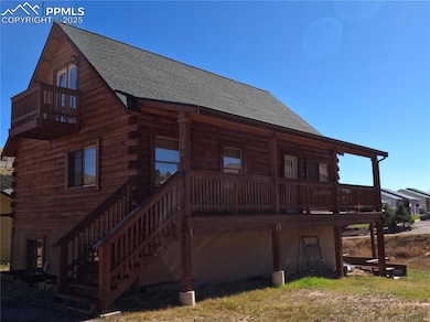 View of side of property with roof with shingles, log siding, and a porch
