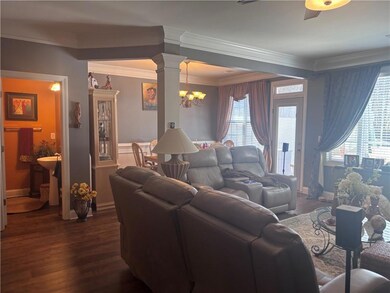 Living room featuring dark wood-style floors, deco