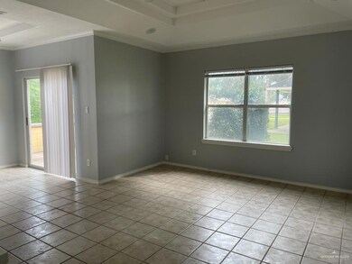 Unfurnished room with crown molding, light tile patterned floors, and a raised ceiling