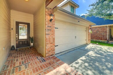 Long driveway into your 2 car garage offers extra parking and brick exterior home.