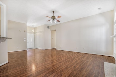 Kitchen opens to living room; hallway leads to 3 b