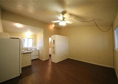 Kitchen with freestanding refrigerator, dark wood